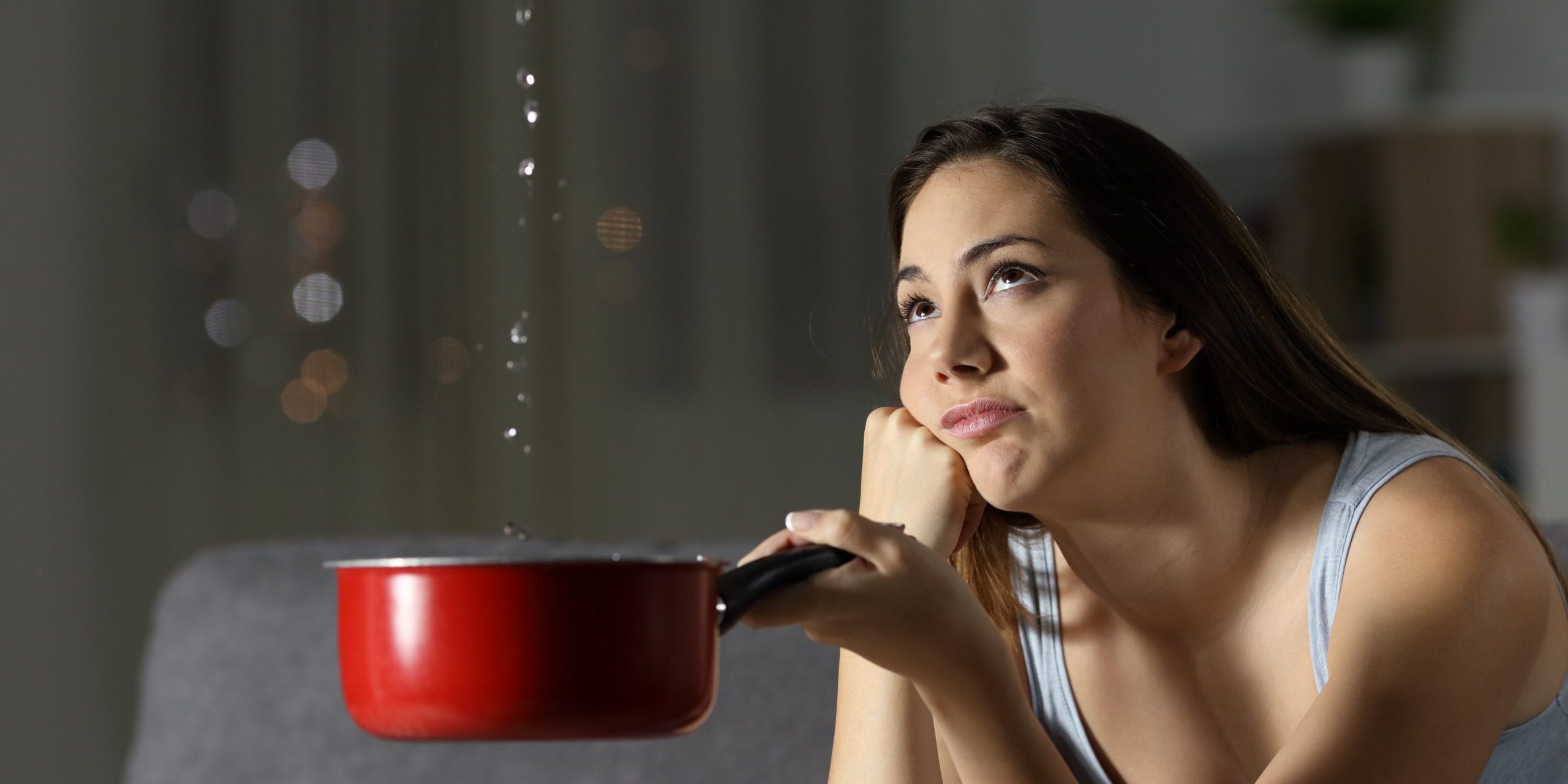 Frustrated,Woman,Looking,At,Home,Water,Leaks,Sitting,On,A