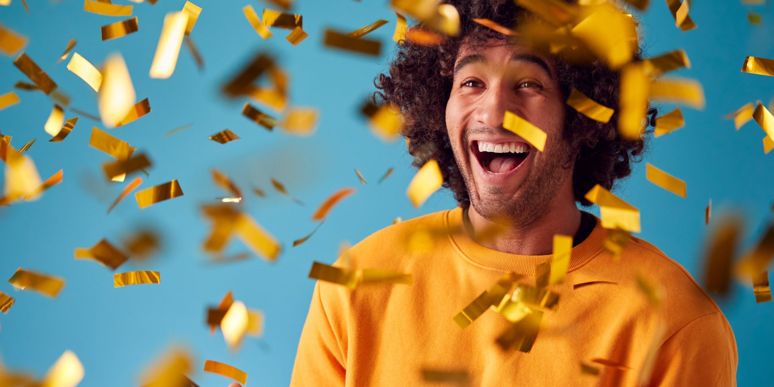 Celebrating,Young,Man,With,Mobile,Phone,Winning,Prize,And,Showered